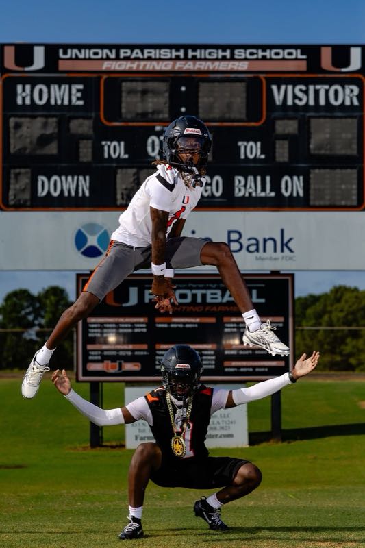 Union Parish High School players under their football scoreboard