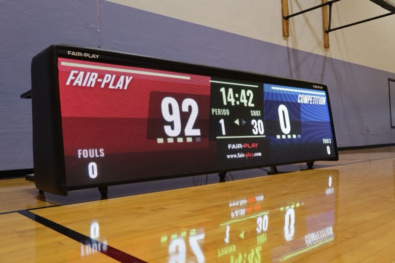 Fair-Play LED video scorer’s table on a gym floor showing score, game clock and shot clock