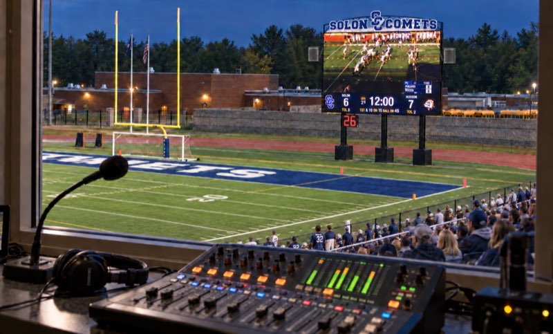 Press box sound mixer and microphone overlooking a stadium