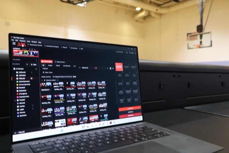 Fair-Play Fusion scoreboard software open on a laptop courtside in a gym